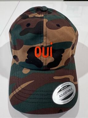 The Classic Camo Dad Hat with orange oui embroidery
